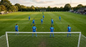 Amateur soccer team lined up in formation, seen from behind the goal